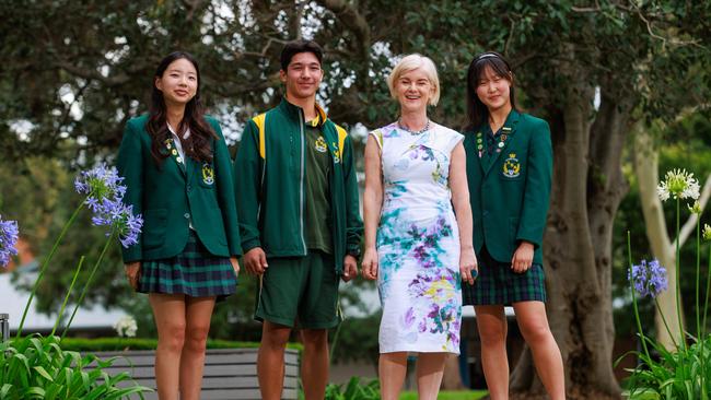 Award-winning debater Nara Gong, 16, champion swimmer and future Olympian Riley Marcellino, 14 and ‘Each for Equal’ club president Yoobin Kim, 16, with their school principal Rachel Powell. Picture: Justin Lloyd.