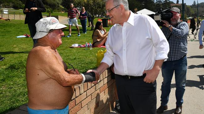 Prime Minister Scott Morrison shakes the hand of a local during a visit to Bronte Beach. Picture: AAP