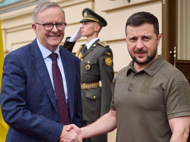 This handout picture taken and released by the Ukrainian presidential press service on July 3, 2022, shows Ukrainian President Volodymyr Zelensky (R) and Australia's Prime Minister Anthony Albanese (L) shaking hands prior to their meeting in Kyiv. (Photo by UKRAINIAN PRESIDENTIAL PRESS SERVICE / AFP) / RESTRICTED TO EDITORIAL USE - MANDATORY CREDIT "AFP PHOTO /  UKRAINIAN PRESIDENTIAL PRESS SERVICE " - NO MARKETING - NO ADVERTISING CAMPAIGNS - DISTRIBUTED AS A SERVICE TO CLIENTS