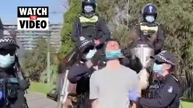 Victorian police put mask on protester