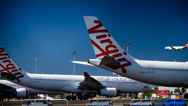 Virgin Australia aircraft are seen parked on the tarmac at Brisbane International airport. Picture: AFP