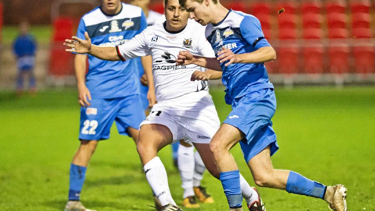 IN CONTROL: South West Queensland Thunder midfielder Daniel Weber (right) eases past Magpies Crusaders FC player Ezra Kennell during their NPLQ clash at Toowoomba's Clive Berghofer Stadium on Saturday. The match finished in a 1-1 draw. Picture: Nev Madsen