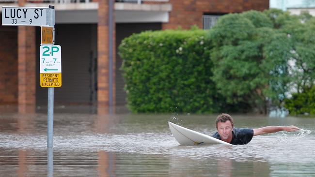 Resident Scott Sherwin paddles to his Lucy Street house in inner city Milton on Wednesday 12, 2011.