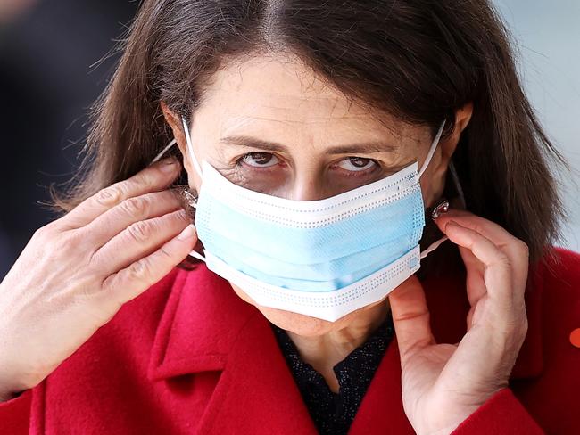 SYDNEY, AUSTRALIA - JULY 12:  NSW Premier Gladys Berejiklian replaces her face mask as she leaves a COVID-19 update press conference on July 12, 2021 in Sydney, Australia. Lockdown restrictions have been tightened across NSW as COVID-19 cases continue to emerge in the community.  Eestrictions are in place across Greater Sydney, the Blue Mountains, the Central Coast and Wollongong with all residents subject to stay-at-home orders are only permitted to leave their homes for essential reasons, including purchasing essential goods, accessing or providing care or healthcare, work, education and exercise. As of 5pm on Friday, exercise is limited to within a 10km radius from home or within the local government area, and with a maximum of two people per group. Browsing in shops is prohibited and only one person per household can leave home for shopping per day. Outdoor public gatherings are limited to two people, while funerals are limited to 10 people only. (Photo by Mark Kolbe/Getty Images)