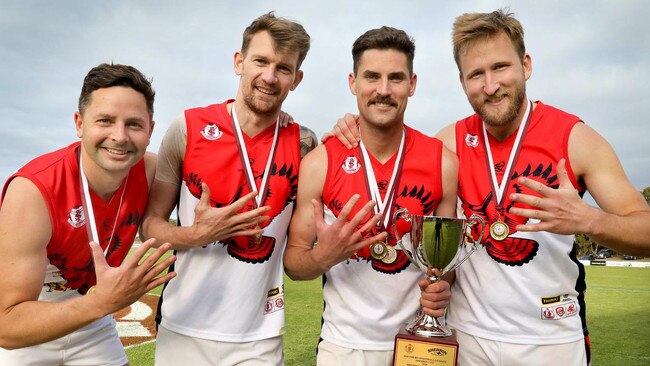 Brad Kirk (right) with (L-R) Daniel Butcher, Mitchell Fazekas and David Kearsley after the Falcons’ 2020 grand final win. Picture: Dean Martin