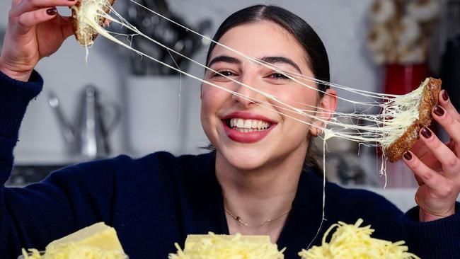 Coles cheese story - Estelle Rose, 24, with a stringy cheese toastie. Picture: Martin Keep