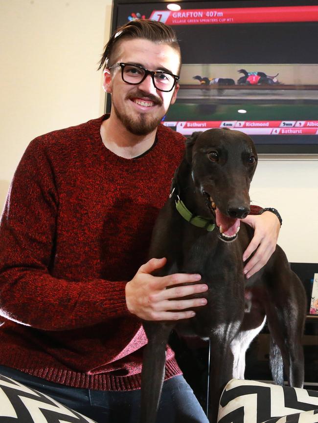 Kyle Vos with his adopted greyhound Teddy. The shutdown will include a strategy for rehoming dogs. Picture: Peter Ristevski