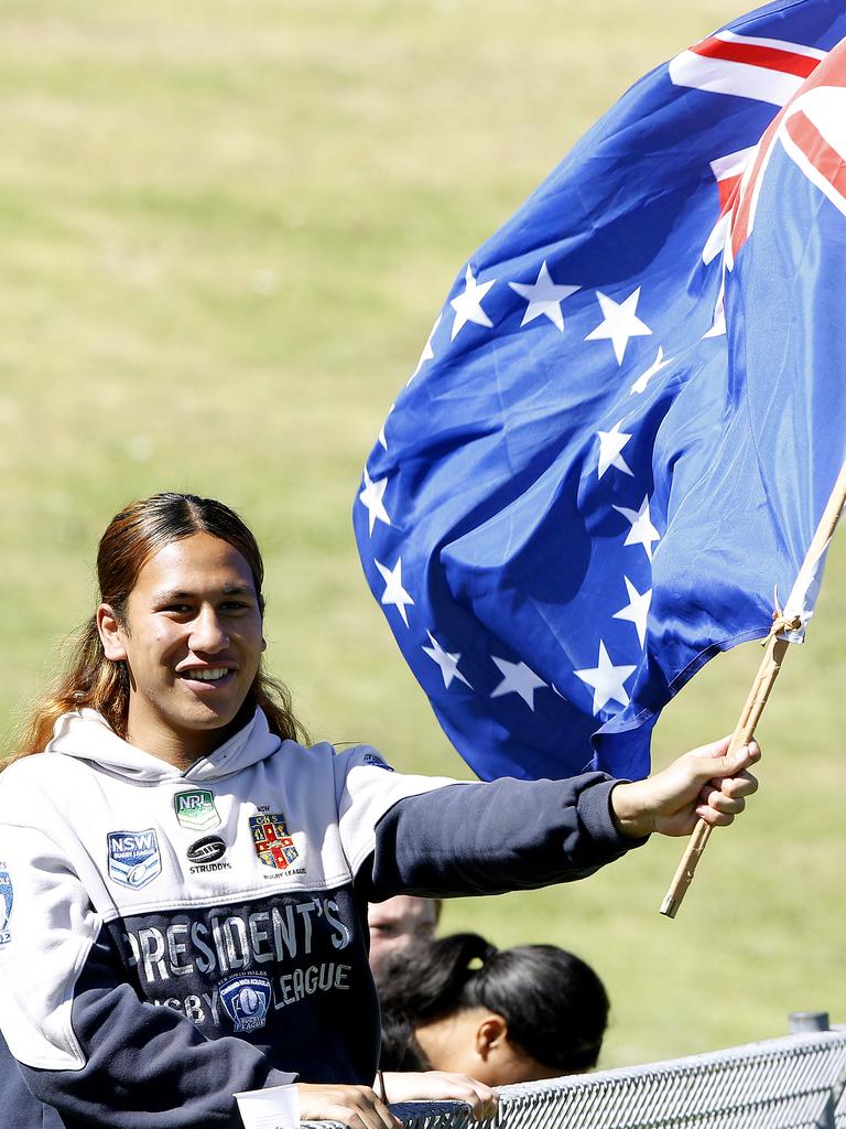 Leka Teinakere waves the Cook Islands flag. Harmony Nines Rugby League. Picture: John Appleyard