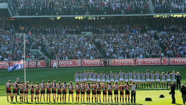 Essendon and Collingwood line up for the national anthem and Last Post before their 2011 clash.