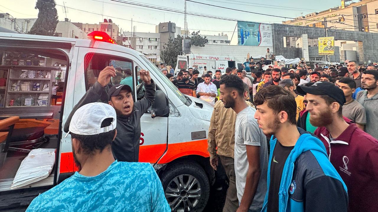 People gather around an ambulance damaged in an Israeli strike in front of Al-Shifa hospital in Gaza City on November 3. Picture: AFP