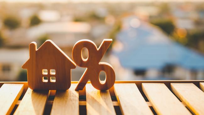 Percentage and house sign symbol icon wooden on wood table. Concepts of home interest, real estate, investing in inflation. mortgage home loan interest rates generic