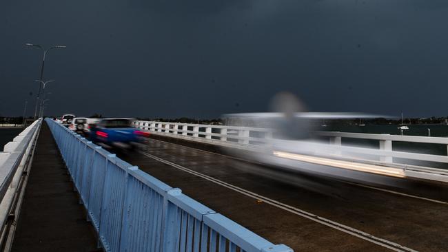 A storm cell passes over the bridge to Bribe Island as wild weather lashes south east Queensland. Photo Lachie Millard