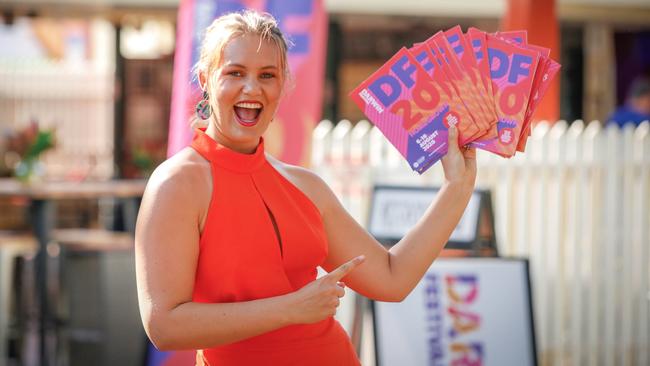 Local comedian Amy Hetherington with newly released programs for the 2020 Darwin Festival. Picture: Glenn Campbell