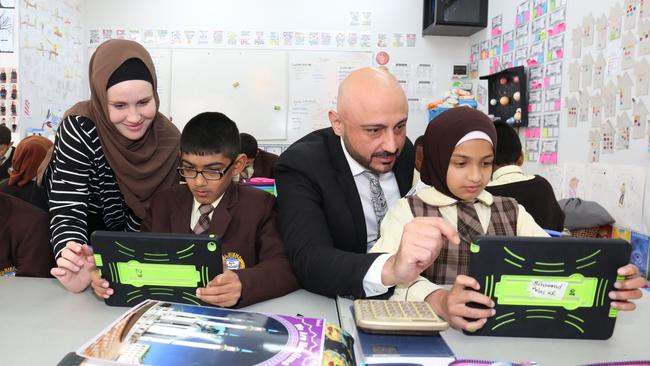 Al Hikma College teacher Ms Jade McGinty, student Saim Muhammad,10, principal Alan Khoder and student Maryum Khaira, 10. Picture: Robert Pozo