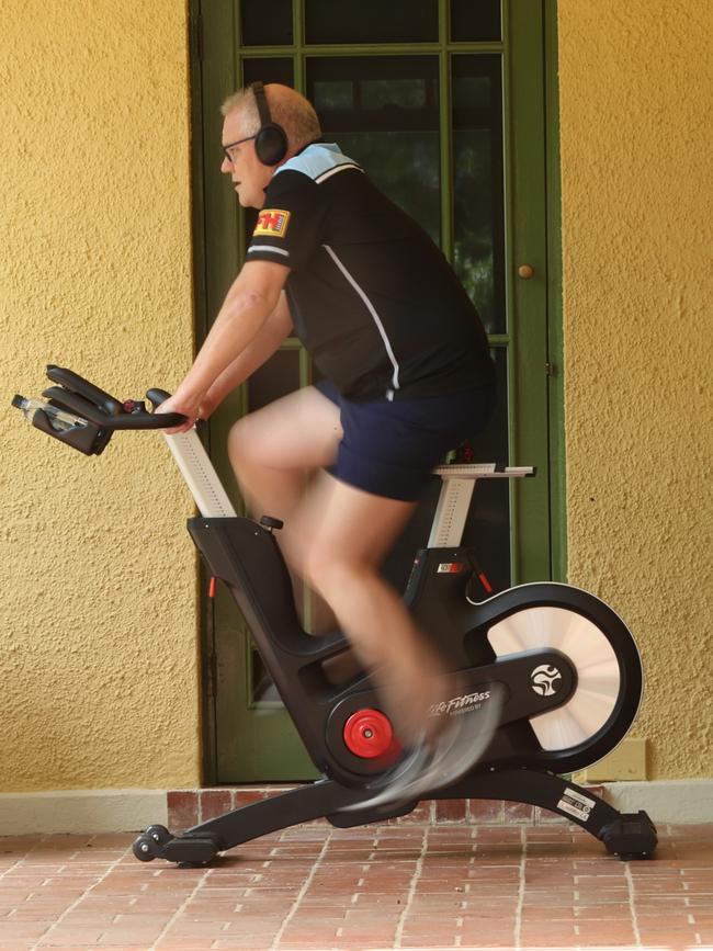 The PM works out on an exercise bike. Picture: Adam Taylor