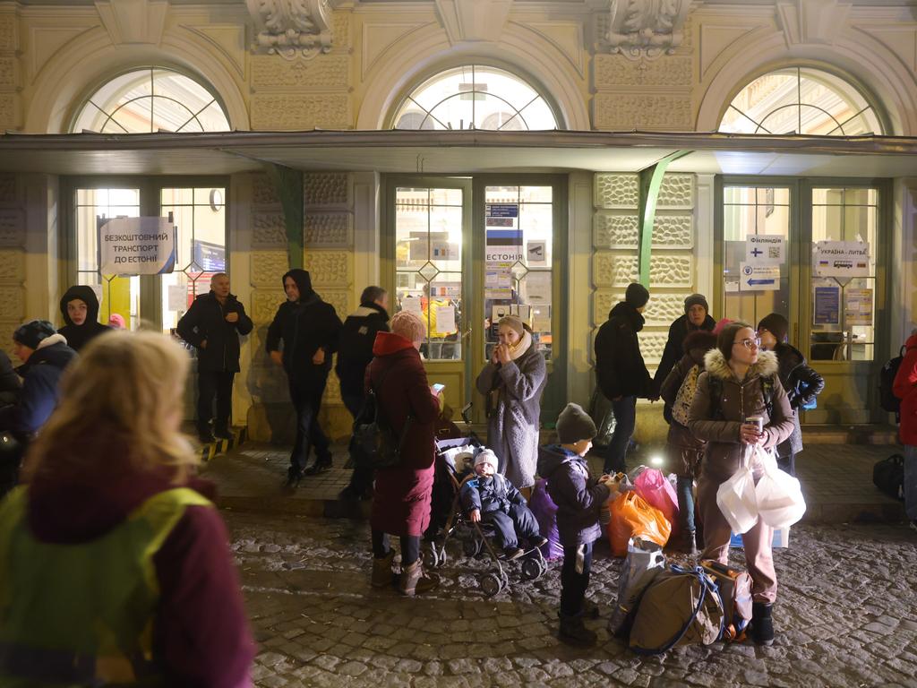 People who have arrived from war-torn Ukraine wait to board buses outside the main railway station in Przemysl, Poland. Picture: Sean Gallup/Getty Images