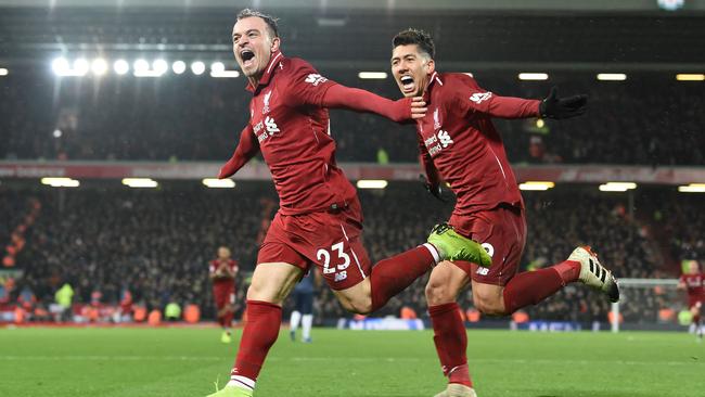 Shaqiri wheels away in celebration with Roberto Firmino.