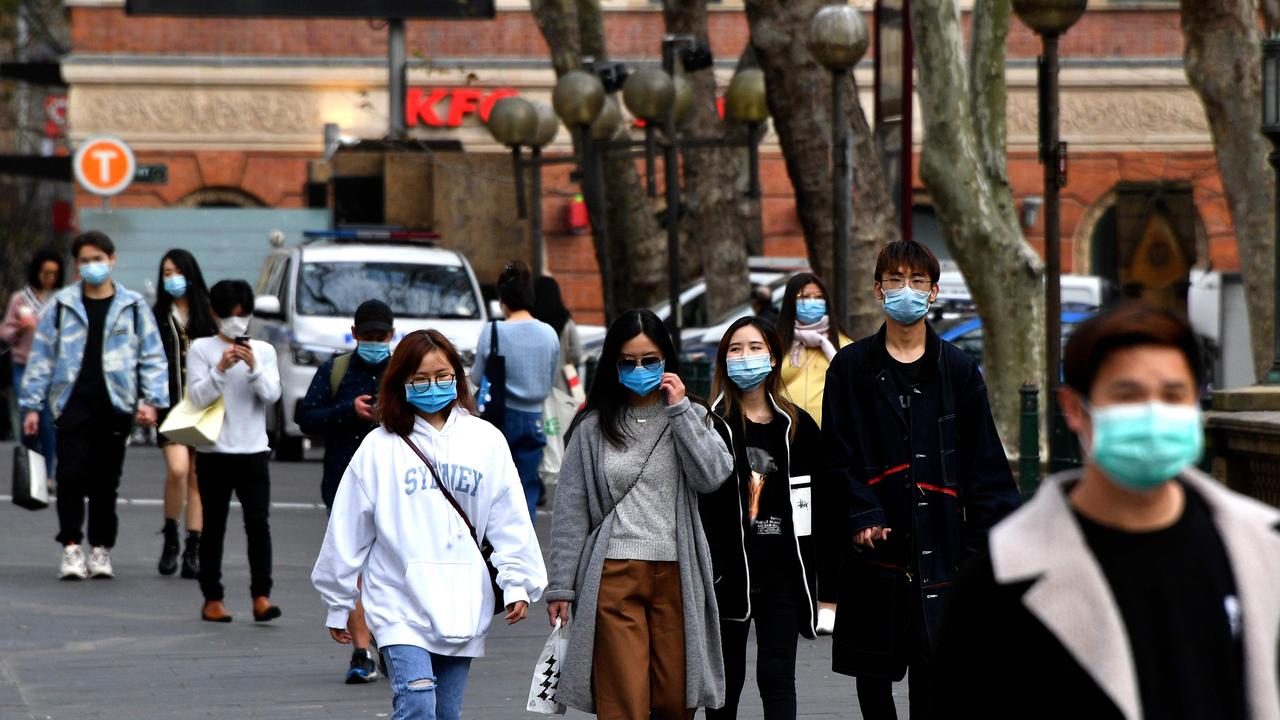 Young people doing their bit and wearing face masks in Sydney CBD on Monday. Picture: Saeed Khan/AFP