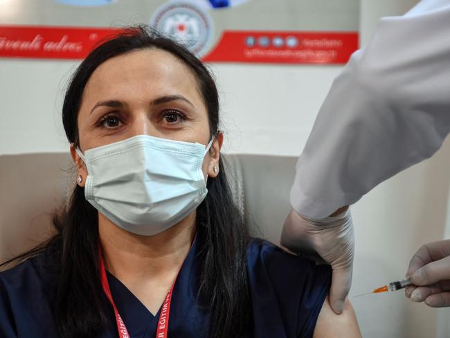 A medical worker receives an injection of the Chinese Sinovac Covid-19 vaccine at Kartal Lutfi Kirdar Sehir Hospital in Istanbul, on January 14, 2021. - Turkey on January 13 approved the emergency use of a coronavirus jab developed by China's Sinovac, paving the way for a national vaccination drive that will start with healthcare workers. (Photo by Ozan KOSE / AFP)