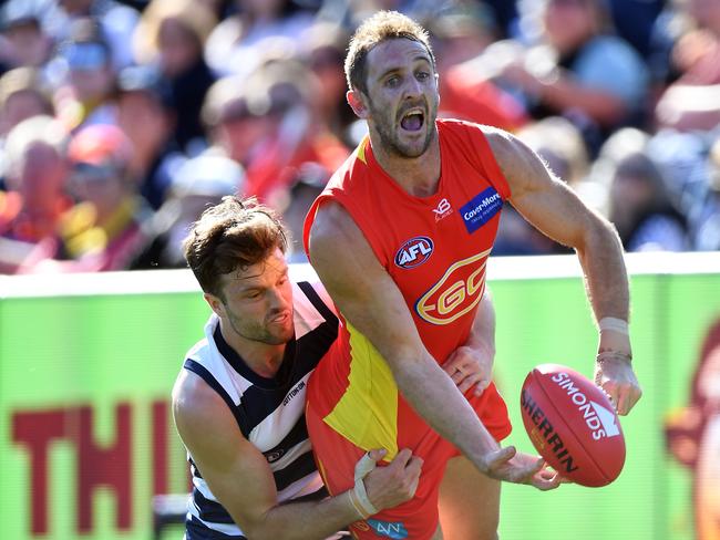 Michael Barlow of the Suns (right) and Jordan Murdoch of the Cats contest during the Round 23 AFL match between the Geelong Cats and the Gold Coast Suns at GMHBA Stadium in Geelong, Saturday, August 25, 2018. Picture: AAP Image/Julian Smith.