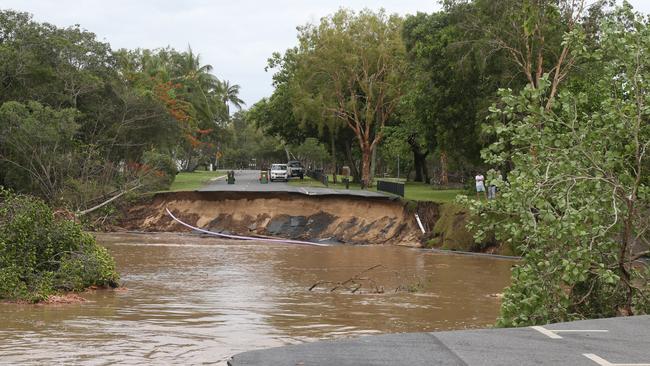 A huge section of Casuarina St at Holloways Beach has been swept away by the torrent that tore through the Cairns suburb on Sunday. Picture: Peter Carruthers