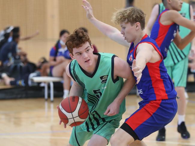 Champion Basketball School of Queensland tournament.  Coomera Anglican College v Trinity College Beenleigh in Boys Junior Division 2 . Coomeras Jack Perkins covered by Trinitys Jacob Miller. Picture Glenn Hampson