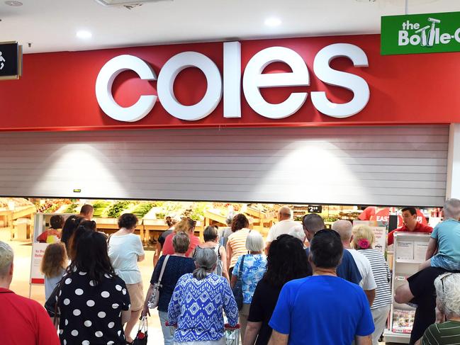 Getting in early - Shoppers lined up outside Coles to make sure they got what they needed. Photo: Cody Fox