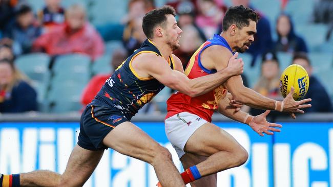 Crow Luke Brown tackles Lion Charlie Cameron in Round 16. Picture: Daniel Kalisz/Getty Images