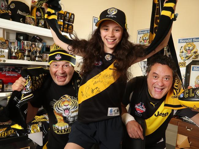 Footy fans are excited that footy is returning this week.Picture: Alex Coppel.  Ron Issko with Carmen, 12, and Phillip Blumenthal ready for action. Picture: Alex Coppel.