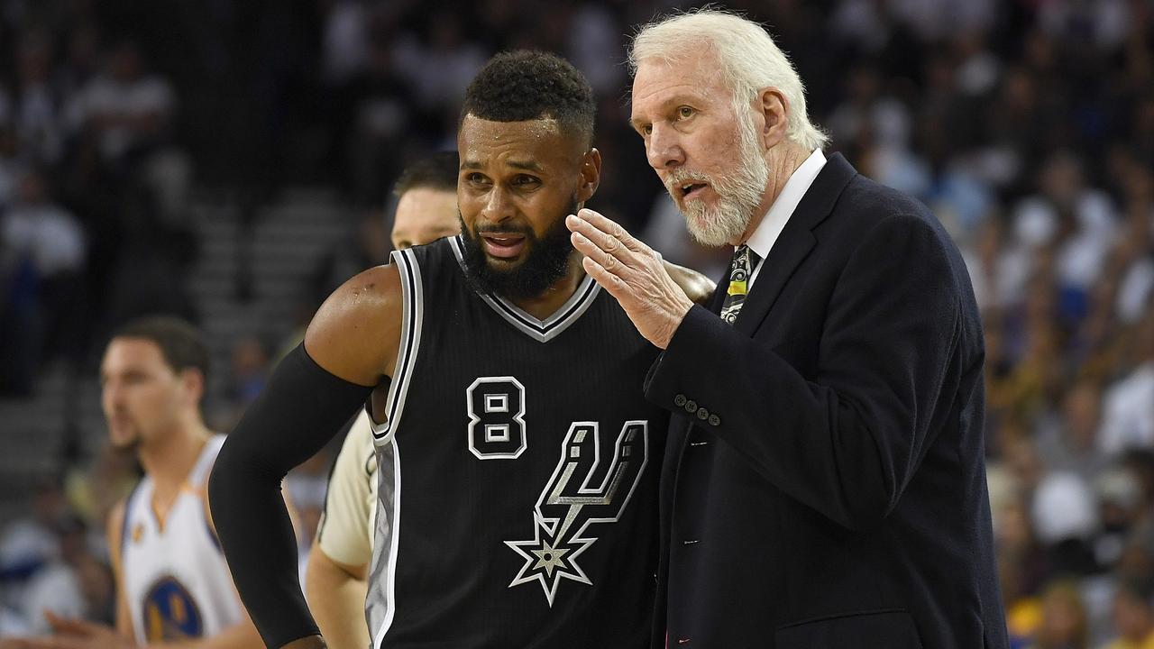 Gregg Popovich speaks with Patty Mills during a game in 2016. Picture: AFP