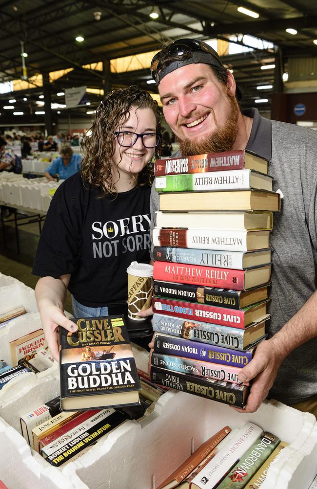 Sarrah Boyle and Luke Zylstra with books collected at The Chronicle Lifeline Bookfest at Toowoomba Showgrounds, Saturday, March 1, 2025. Picture: Kevin Farmer