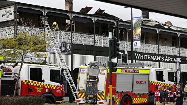 NSW Fire and Rescue clean up after putting out the fire damaged Whiteman's Arcade Camden the 18th of September. Picture: Adam Yip