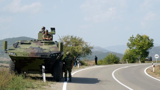 Serbian army soldiers stand guard by their armoured vehicle in the village of Rudnica near the Serbian town of Raska on September 27, 2021, where tensions are high between Kosovo and Serbia. Picture: AFP