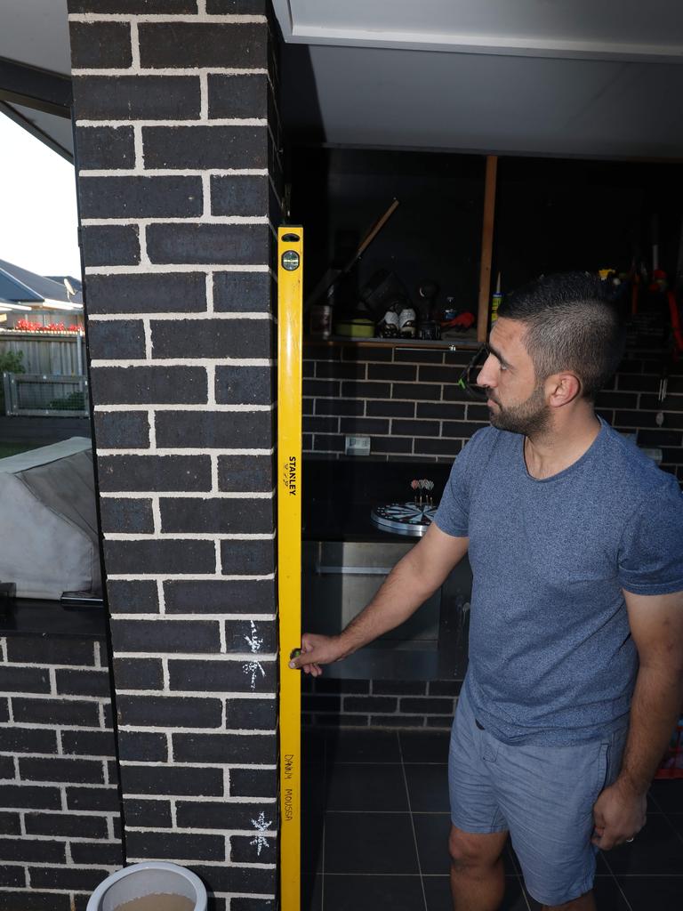 Danny Moussa showing the damage to his home in Spring Farm. Picture Damian Shaw