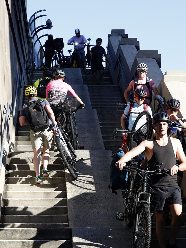 Rush hour for cyclists, climbing the stairs in Milsons Point up to the Harbour Bridge cycleway. Picture: Jonathan Ng