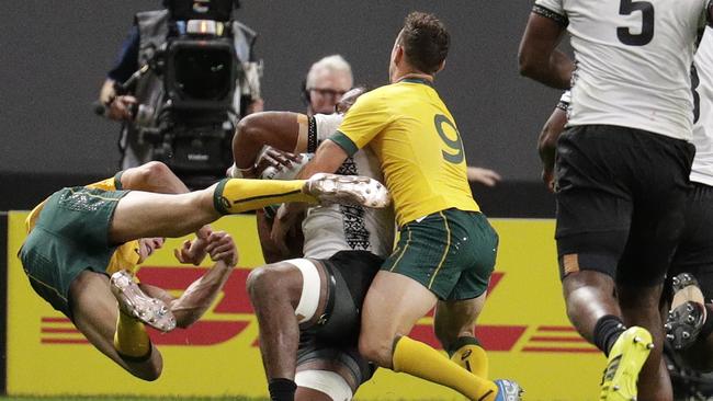 Wallaby winger Reece Hodge goes flying after his contact with Peceli Yato. Picture: AP