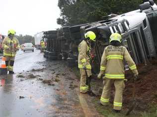 TRUCK ROLLOVER: A semi-trailer carrying a load of chickens has rolled over on Ballina Rd, Goonellabah. The driver was rescued by local passers-by. Picture: Alison Paterson