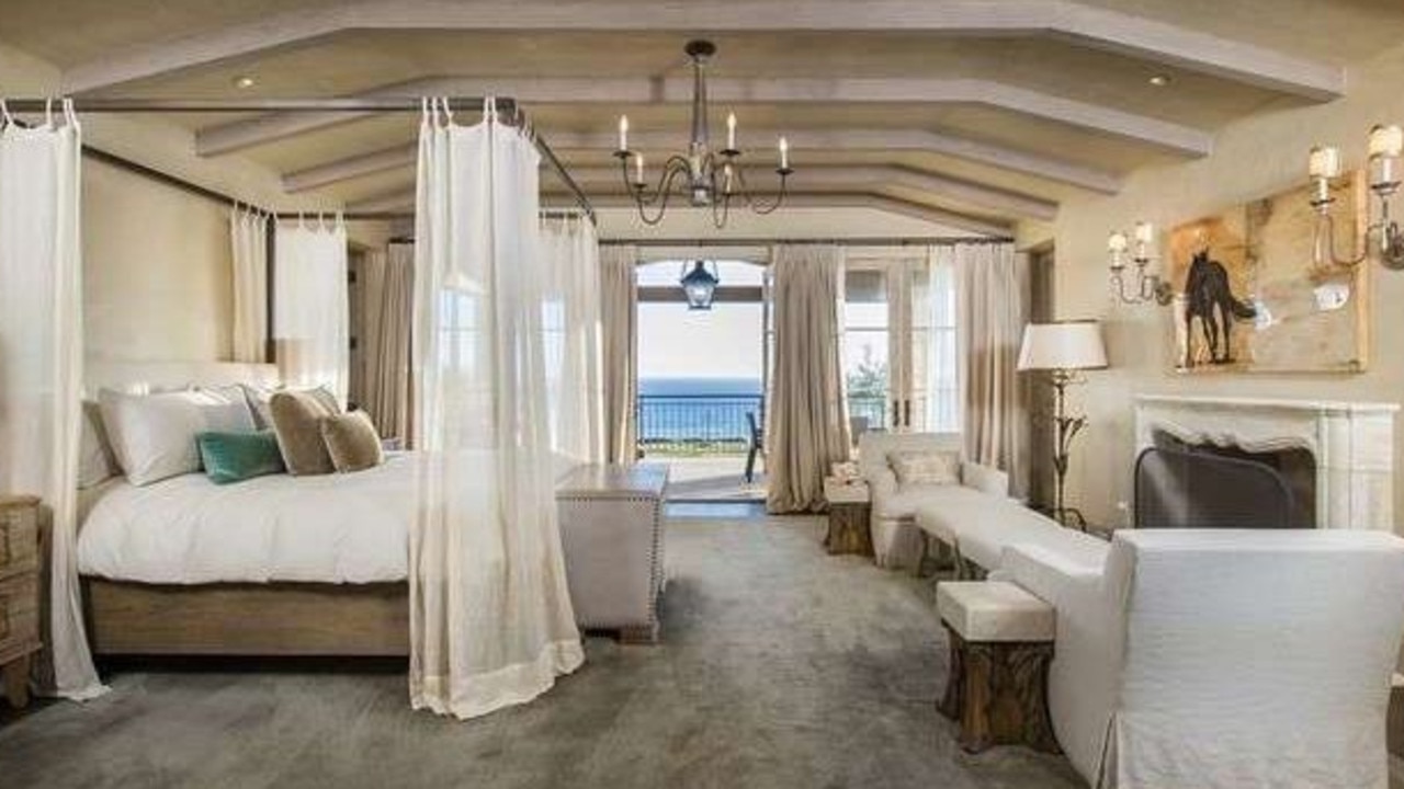 The stunning bedroom looks out onto the water. Picture: Realtor