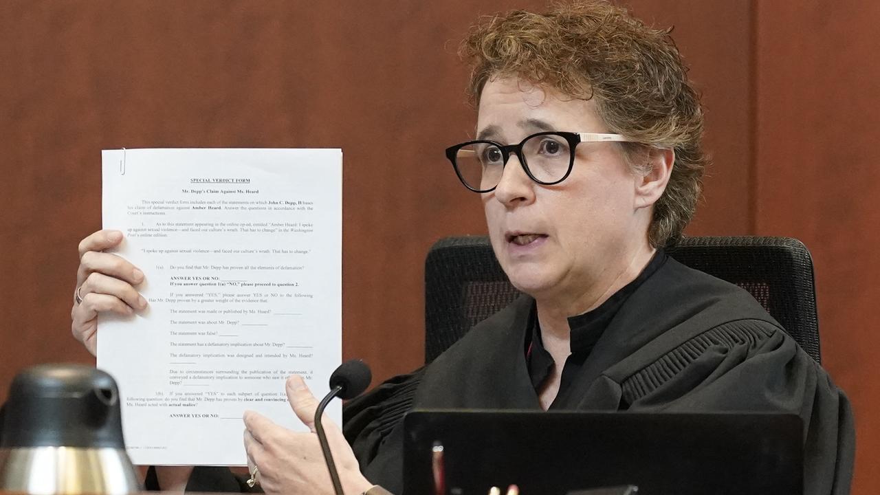 Judge Penney Azcarate holds up the jury instructions after closing arguments including the 42 questions. (Photo by Steve Helber / POOL / AFP)