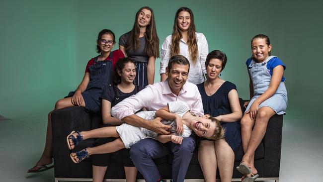 Dr Justin Coulson with his wife Kylie, 41 and daughters left to right Annie, 12, Ella, 16, Abbie, 17, Chanel, 20, Lilli, 9, and Emilie, 5. Picture: Mark Cranitch