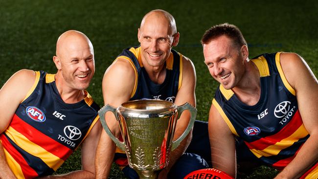 8/6/17 1997 premiership players Nigel Smart, Tyson Edwards and  Matthew Robran with the 1997 AFL Premiership Cup at The Adelaide Crows Football Club. Picture by Matt Turner.