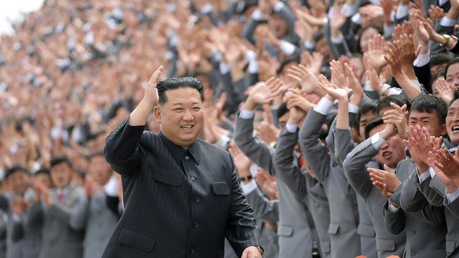 Kim Jong-un greets students and working youths during the military parade that appears to have become the country’s first super-spreader event. Picture: KCNA/KNS/AFP