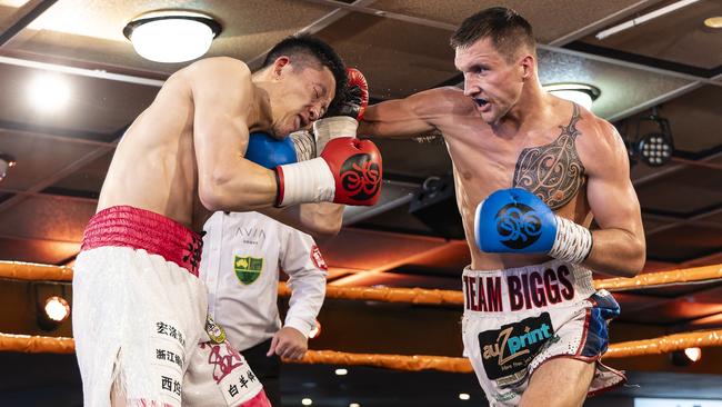 Dylan Biggs lands a shot on Yeze Wu during their WBC Australasia middleweight title fight. Picture: Darren Burns