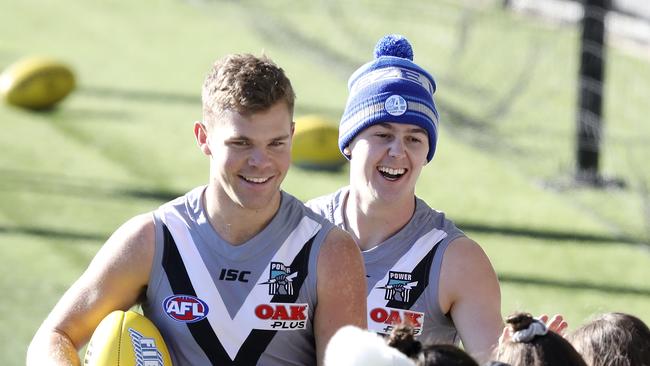 Darcy Byrne-Jones, right, with Dan Houston at Port training discovered the hard way that missing a meeting is no laughing matter. Picture SARAH REED