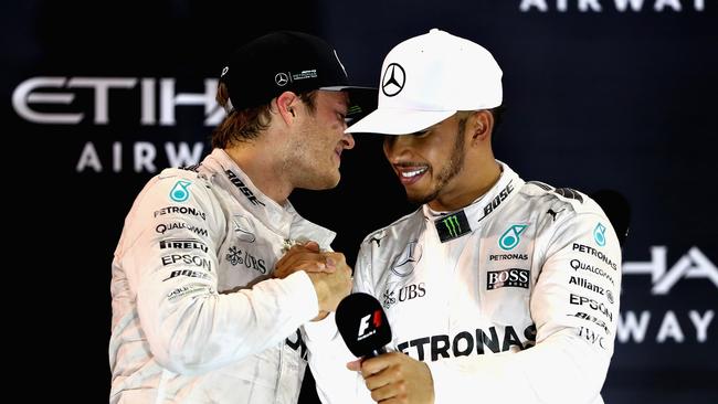 Lewis Hamilton and Nico Rosberg share an awkward embrace on the Abu Dhabi podium.