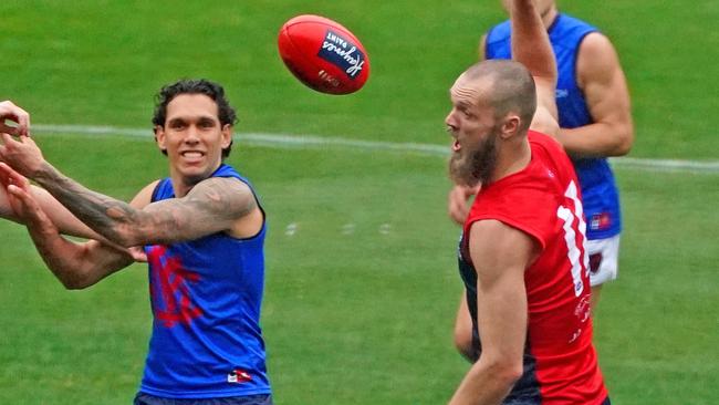 Harley Bennell and Max Gawn train at the MCG on Sunday after Melbourne’s match against Essendon was postponed. Picture: AAP