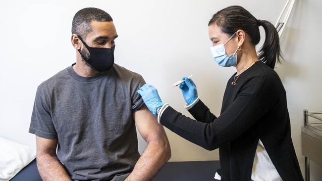 Risks of blood clots ‘insignificant’: Callum Silcock receives his AstraZeneca vaccination from Adrienne Chan. Picture: Aaron Francis