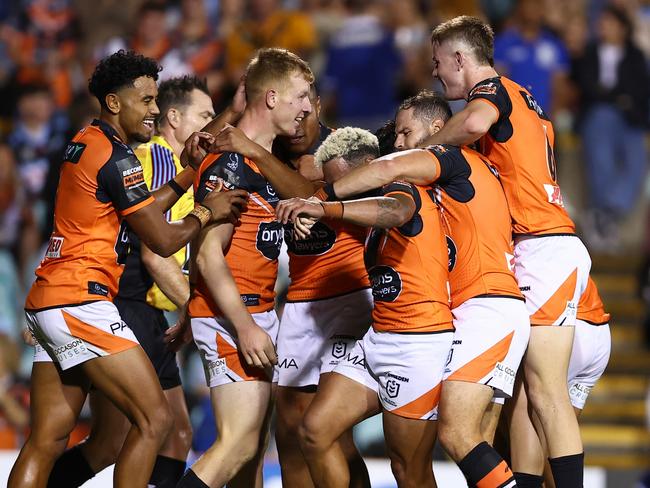 SYDNEY, AUSTRALIA - MARCH 23: The Tigers celebrate a try by Alex Seyfarth of the Tigers during the round three NRL match between Wests Tigers and Cronulla Sharks at Leichhardt Oval, on March 23, 2024, in Sydney, Australia. (Photo by Jeremy Ng/Getty Images)