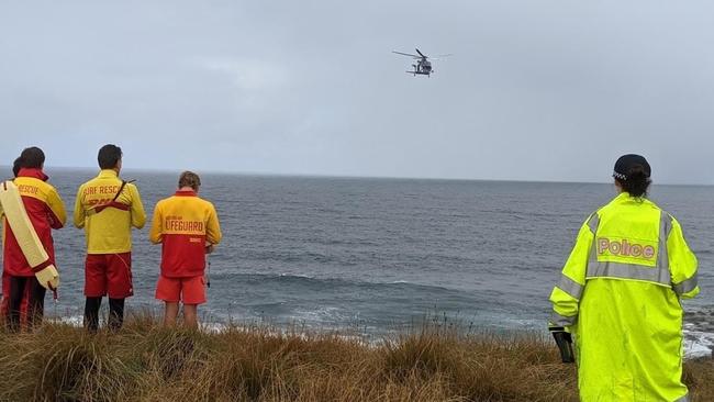 Police and life savers searching for a missing fisherman after he was swept off the rocks.