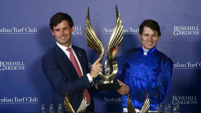 James Cummings and jockey Koby Jennings get their hands on the Golden Eagle trophy. Picture: Getty Images